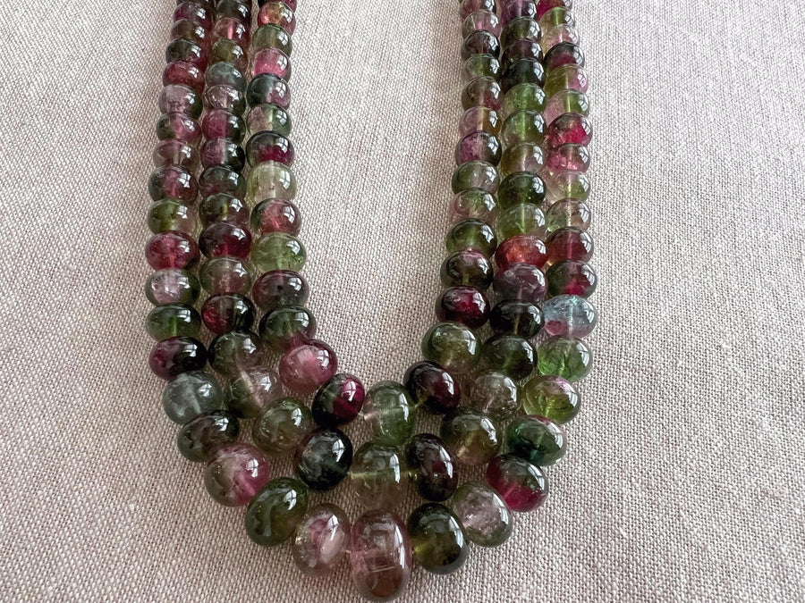 AAA-grade natural bi-color tourmaline smooth rondelle gemstone beads, graduated from 5.5mm to 11mm, featuring beautiful natural color variations for jewelry making. triple strand detail shot of beads