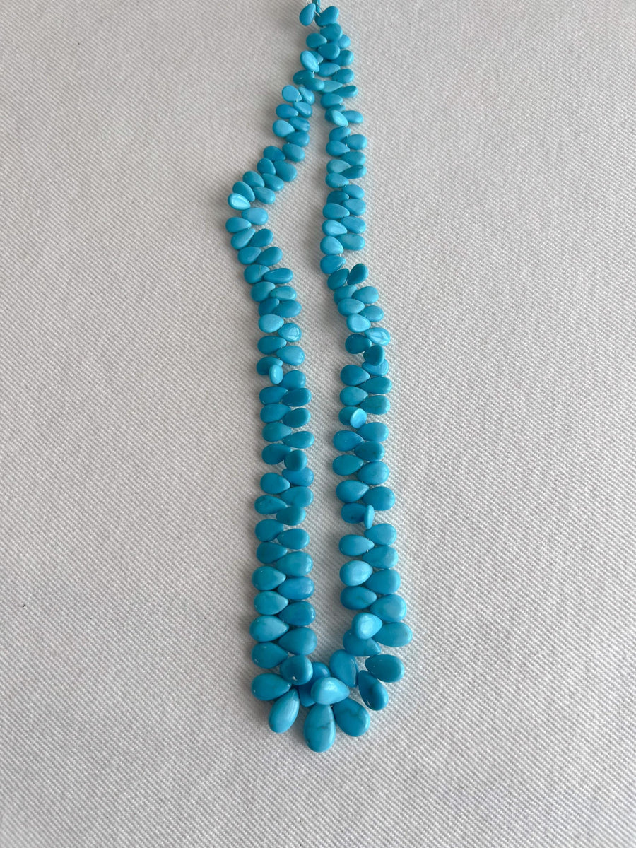 Full strand of AAA natural Sleeping Beauty turquoise smooth almond beads in classic robin's egg blue.
