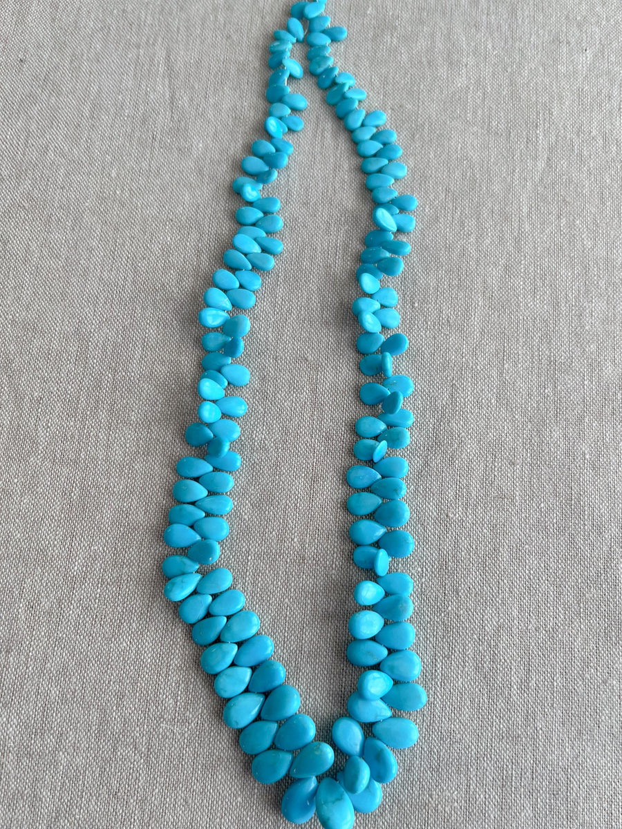 Full strand of AAA natural Sleeping Beauty turquoise smooth almond beads in classic robin's egg blue.