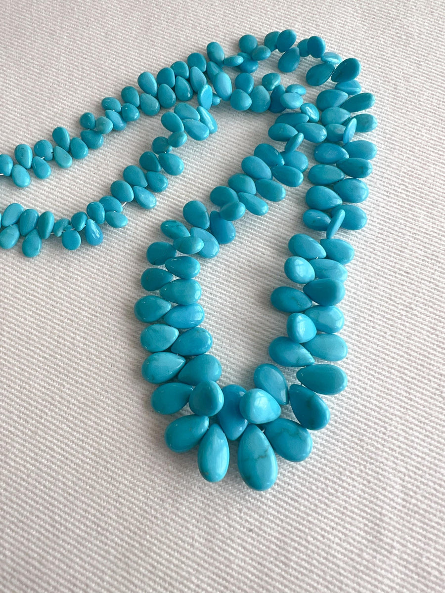 Full strand of AAA natural Sleeping Beauty turquoise smooth almond beads in classic robin's egg blue.