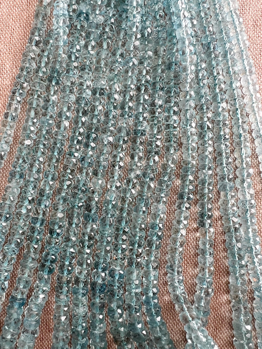 AAA unheated Aquamarine gemstone beads featuring beautiful medium blue color, excellent transparency, and finely faceted rondelle shapes.