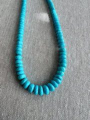 Close-up of AAA Sleeping Beauty Turquoise rondelle beads showing sparkling faceted surfaces, beautiful blue color, and graduated gemstone sizes.