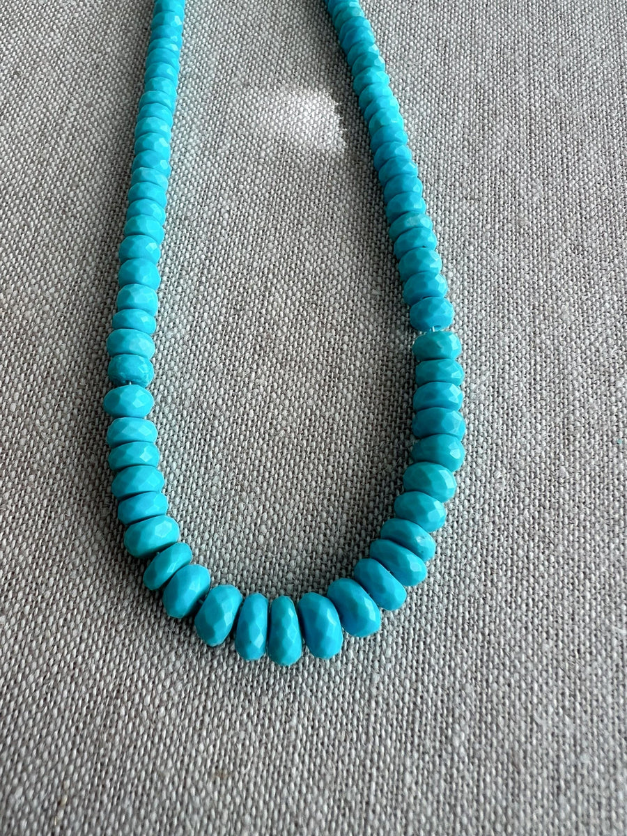 Close-up of AAA Sleeping Beauty Turquoise rondelle beads showing sparkling faceted surfaces, beautiful blue color, and graduated gemstone sizes.