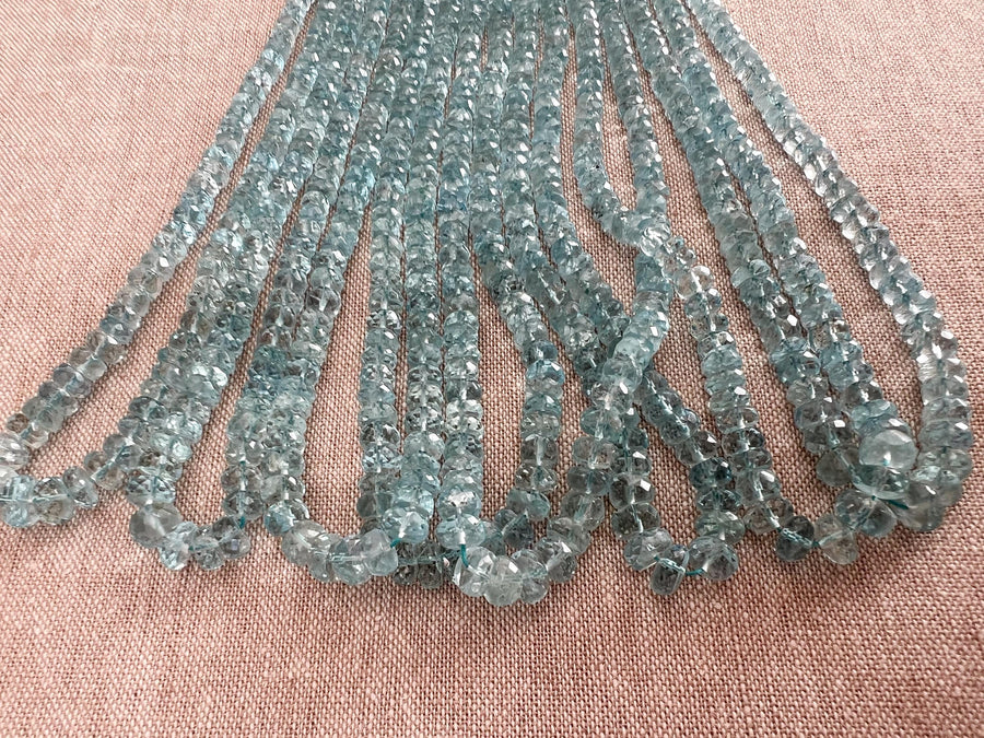 High-grade natural Aquamarine faceted rondelle beads from Brazil, approximately 140 gemstones with consistent blue color and brilliant sparkle.