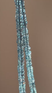Close-up of transparent Santa Maria Aquamarine beads showing exceptional deep blue color, clarity, and sparkling facets. video