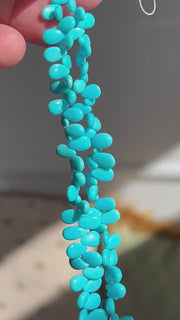 AAA-grade natural Sleeping Beauty turquoise smooth almond-shaped gemstones from Arizona, featuring classic robin's egg blue color and a polished finish.